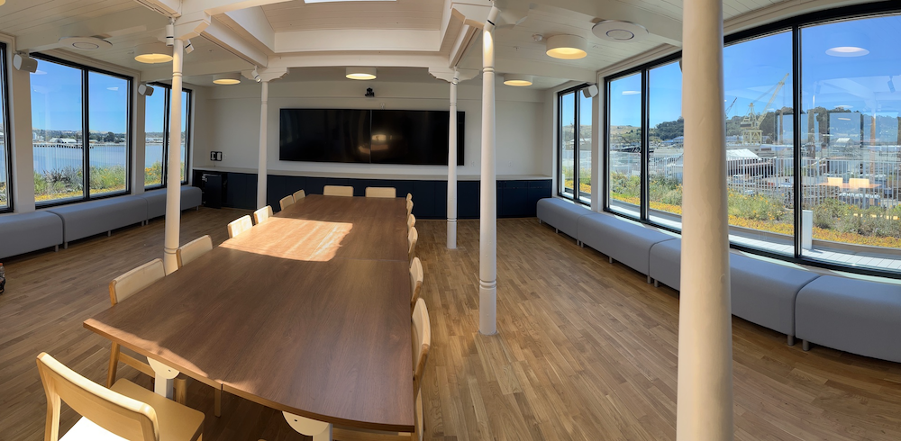 sunny view of board room with meeting table and chairs